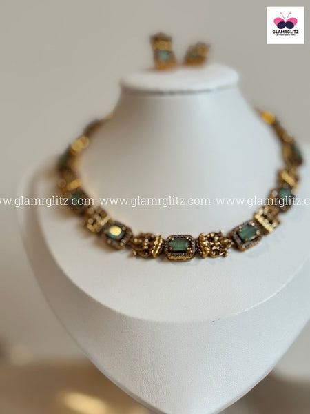 Laxmi Motif Choker with green Stone – Matte Gold Finish
