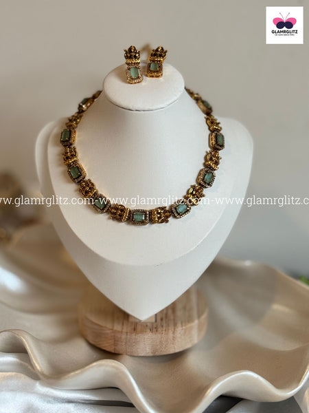 Laxmi Motif Choker with green Stone – Matte Gold Finish