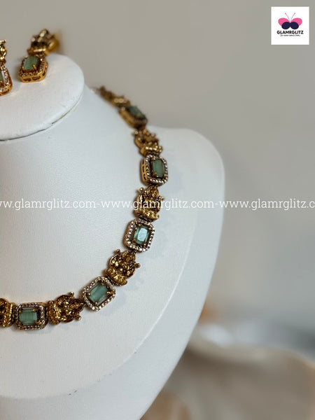 Laxmi Motif Choker with green Stone – Matte Gold Finish