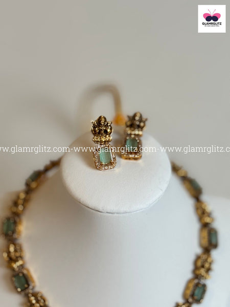 Laxmi Motif Choker with green Stone – Matte Gold Finish
